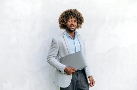 Curly haired elegant handsome brazilian or hispanic man, programmer, IT Stock Photos