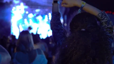 Curly haired girl raving dancing on live concert stage disco background youth Stock Footage 118134853