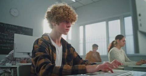 Curly Haired, Handsome Young Man in Sunny Computer Lab is Concentrating on Work Stock Footage 318517798