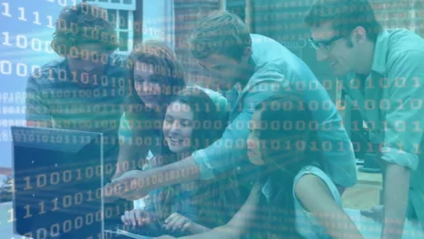 Curly-haired man gesturing binary overlay at teen coding in office, teammates Stock Footage 312298216