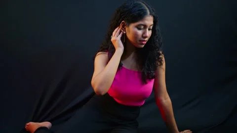 Curly Haired Model Poses Under Vibrant Studio Lights Stock Footage 313669406