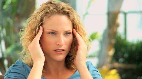 Curly haired woman having an headache Stock Footage