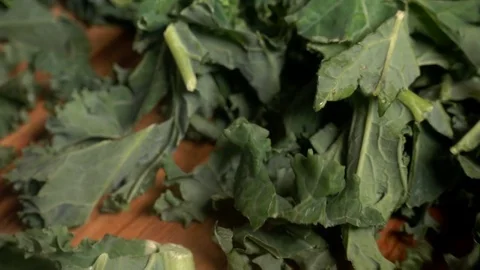 Curly Kale dropped on kitchen worktop, slow motion Stock Footage 77336598