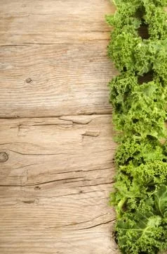 Curly kale on a rustic table Stock Photos