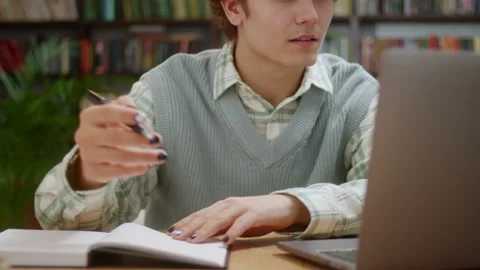 Curly man college student using laptop computer watching distance online Stock Footage 222317012