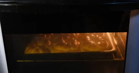 Curly pastry baking inside an electric oven. Opening oven door. Stock Footage 122743396
