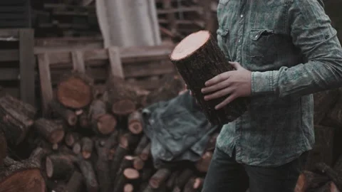 Curly redhead guy with cigarette, chopping a firewood Stock Footage 141023573