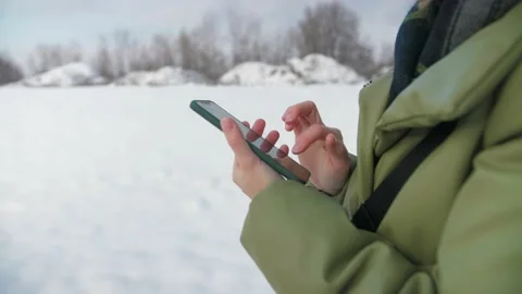 Curly Woman browsing internet using phone outdoor.Girl holding phone and surfing Stock Footage 225934215