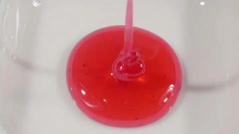 Currant jam is poured into the white piala. Berry jam. Close-up. Red jelly. Stockbeeldmateriaal 140812845