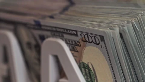 Currency arranged with focus on a hundred dollar bill in cash display Stock Footage 298891406