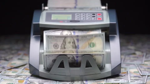 Currency counting machine counts 100 dollar bills or USD banknotes. Cash bill Stock Footage 148623482