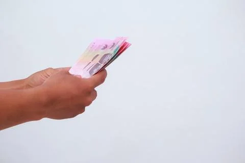 Currency Notes Held By Hands On A Plain Background Stock Photos