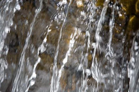 The current falling clear water of the waterfall. Stock Photos