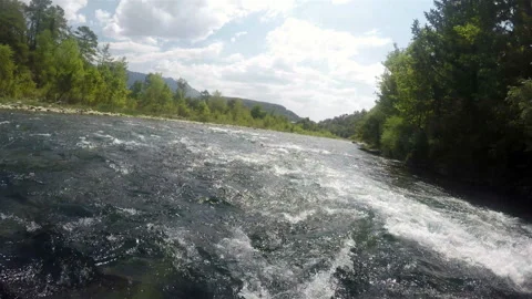 The current of the mountain river turns the boat with tourists between the rocks Stock Footage 128211519