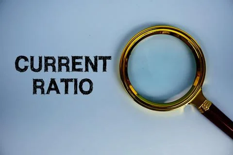 Current Ratio text with magnifying glass on blue background Stock Photos