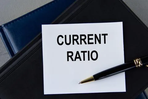 CURRENT RATIO - words on white sheet on a black leather book with pen Stock Photos