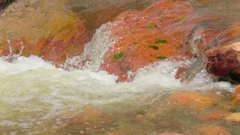 The current of a river flowing over rocks and stones Stock Footage 335894287