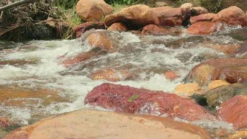The current of a river flowing over rocks and stones Stock Footage 335894727