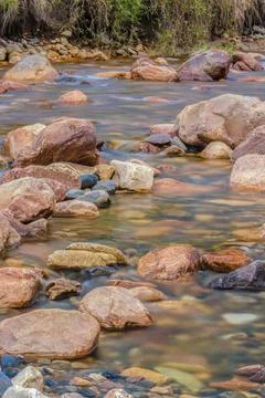 The current of a river flowing over rocks and stones Fotos Stock