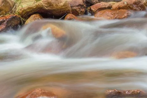 The current of a river flowing over rocks and stones Stock-Fotos