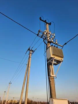 Current transformer, high voltage electric lines on sky background 库存照片