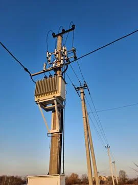Current transformer, high voltage power lines on blue background Stock Photos