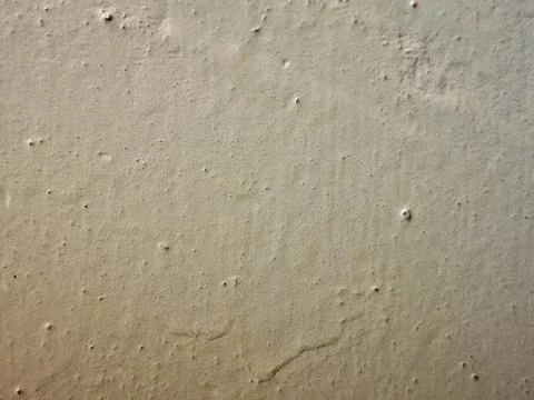 The current white paint on the wall. Brooks of liquid. Vertical flows. Stock Photos
