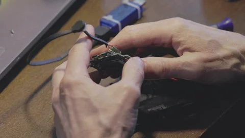 Currently, handson repairs and electronics assembly work is actively in progress Stock Footage 306059794