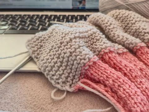 Currently working on a cozy and creative knitting project while using my la.. Stock Photos