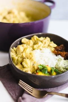Curry chicken with chutney  on a gray ceramic and several side dish Stock Photos