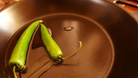 Curry leaves being thrown in a pan with spices, chillies and condiments Vídeo Stock 73975122