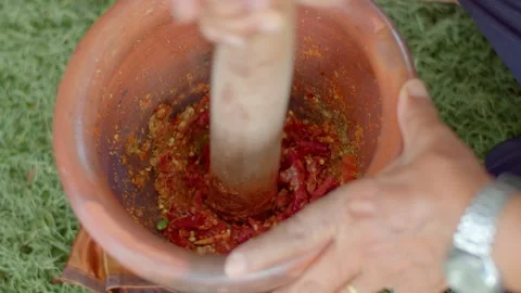 Curry paste in stone mortar.Finely ground the chili with various spices. Stock Footage 240943945