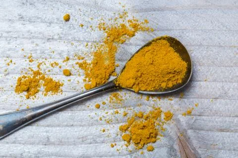 Curry powder on a spoon macro Stock Photos