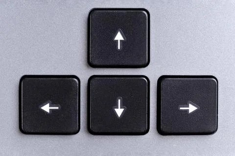 Cursor keys, direction keys or navigation arrow keys on gray computer keyboard Stock Photos