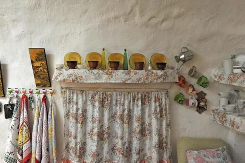 Curtain with decoration of objects from kitchen of cave house Calguerin Cuevas Stock Photos