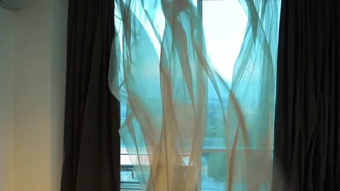 Curtain fluttering in the wind at the window. Wind at the window. Stock Footage 102675540