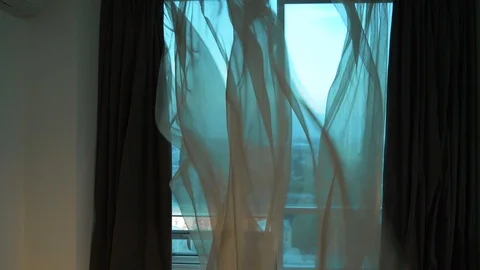 Curtain fluttering in the wind at the window. Wind at the window. Stock Footage 102675571