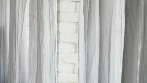 Curtain fluttering in the wind at the window. Wind at the window. Stock Footage 122928907