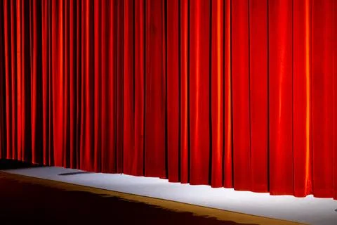 The curtain going down at the end of a play in a theatre hall Stock Photos