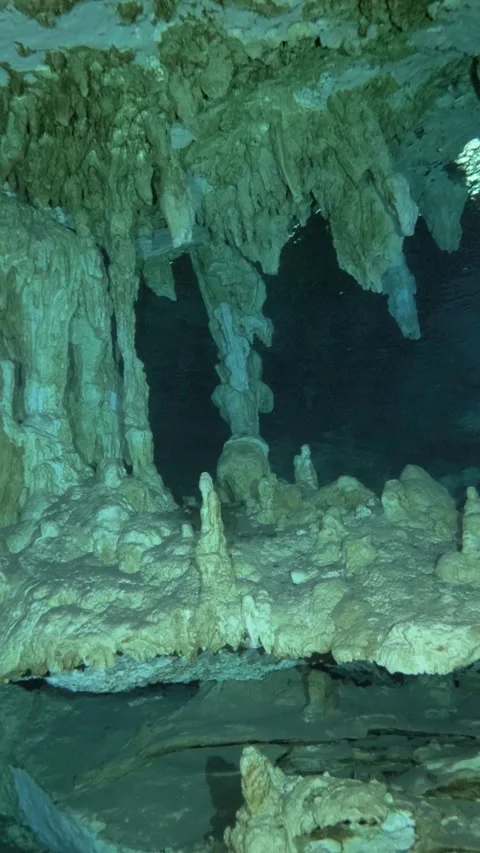 Curtain-like stalactites above a flat cavern floor Video stock 341361608