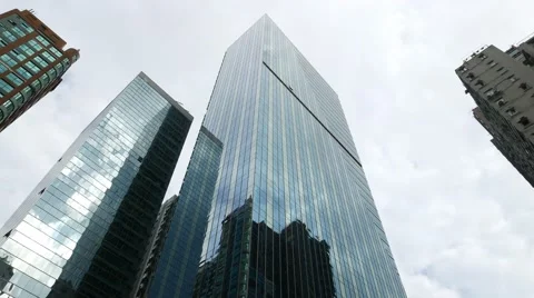 Curtain wall facade low angle shot against cloudy sky, slide camera Stock Footage 55690963