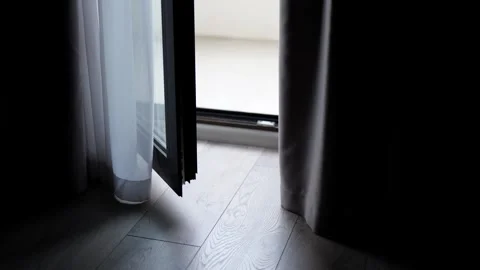 Curtains blowing in the wind in an open door Stockbeeldmateriaal 244723728