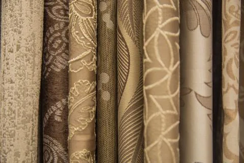 Curtains of different colors and patterns for the room hang horizontally. Stock Photos