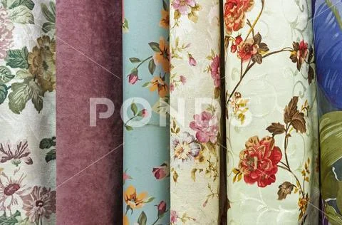 Curtains with floral ornament in the shop window. Fabric with floral pattern. Stock Photos