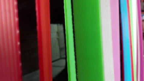 Curtains made from colored futureboards were blowing with the force of the wind. Stockbeeldmateriaal 257547765