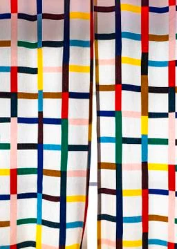 Curtains with multi-colored cells in the interior of the children's room. Stock Photos