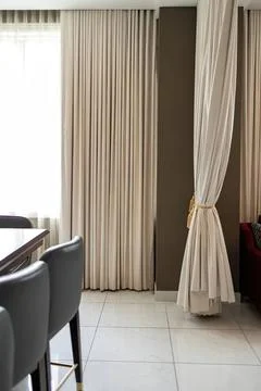 Curtains in a room with a window and dining area Stock Photos