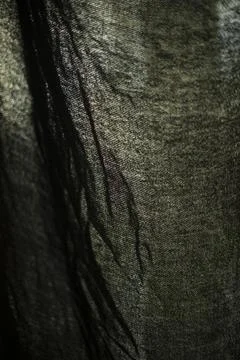 Curtains on window. Light through dark fabric. Texture of fabric in light. Stock Photos