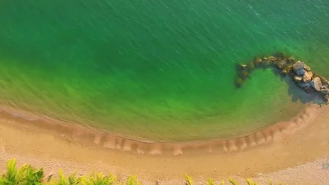 Curve rocks on the beach top view. Loop. Stock Footage 85424286
