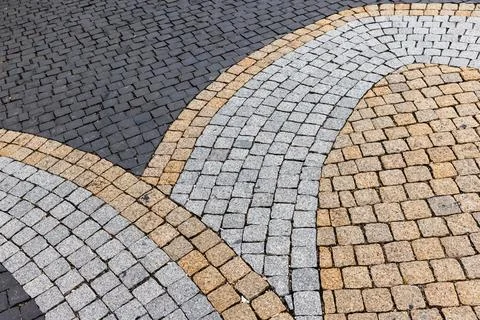 Curved cobblestone pavement with interlocking granite stones forming concen.. Stock Photos